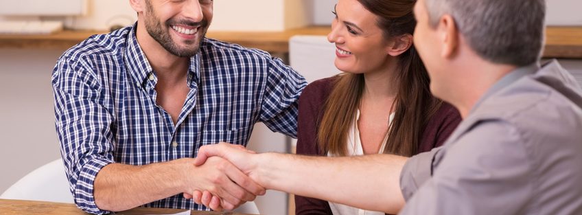 Couple shaking hand to financial agent